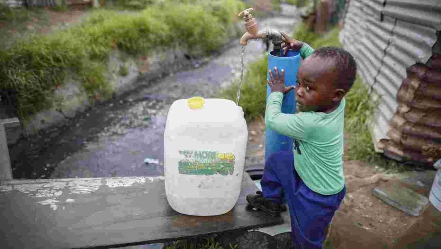 This picture shows a South African boy collecting his water for the entire week. 