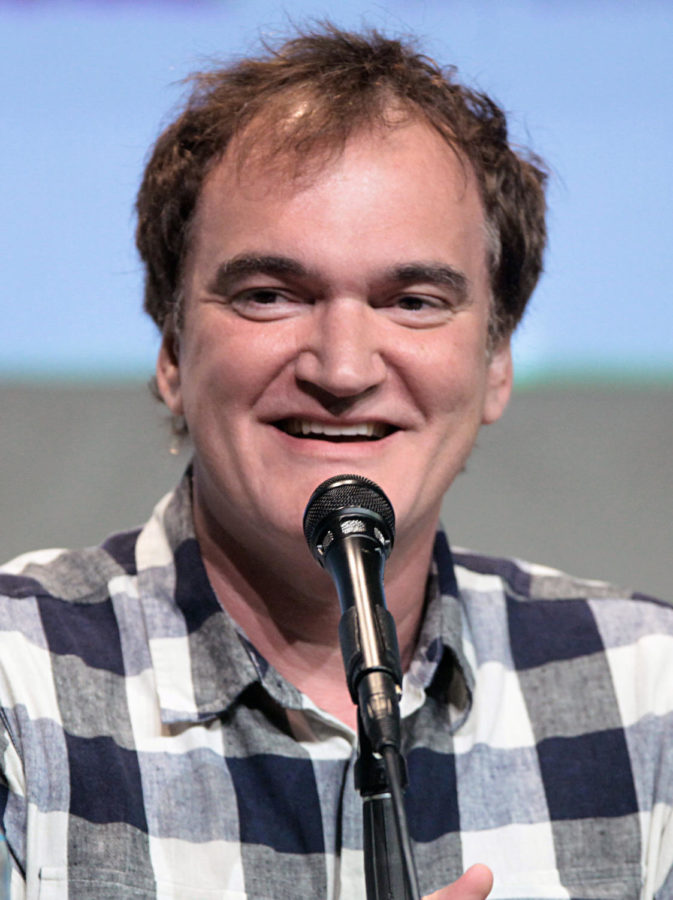 This is a picture of the director Quentin Tarantino during a conference at Comic Con. 