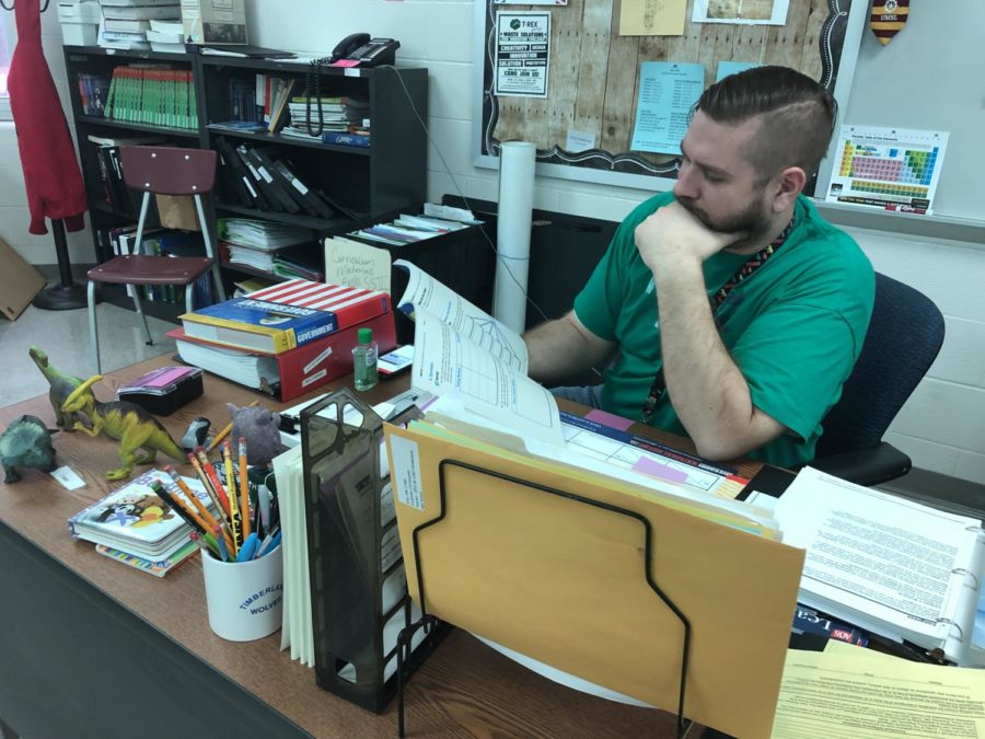 Teacher Chris Codonier at his desk in his classroom on the second floor of THS.