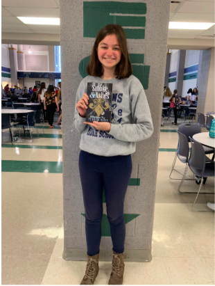 Freshman Peighton Weber holds her first published book, “Smoke and Ashes;” it was published March 17.  “The reason I wrote a book was not because of an inspiration or role model, but because I wanted to create a story of my own,” Weber said. 