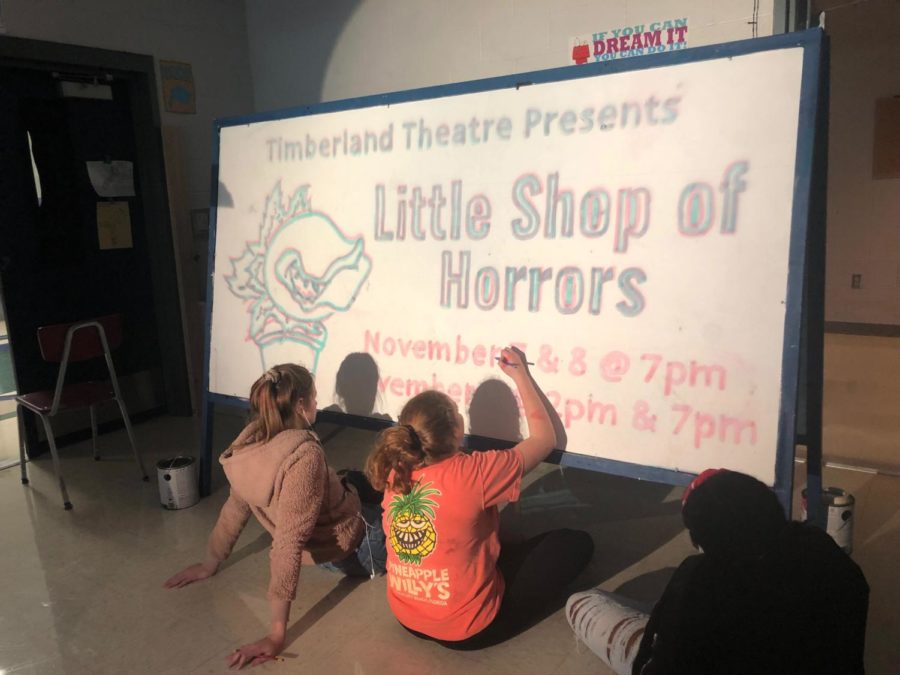 Cast Members creating a sign for Little Shop of Horrors